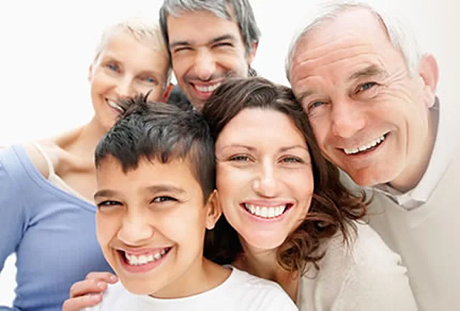 A family of five smiling together