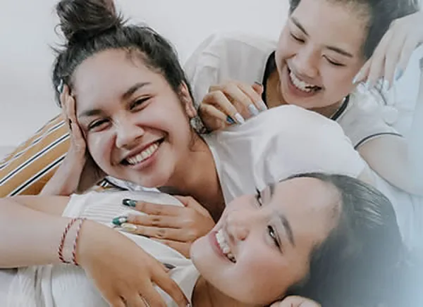 Three friends laughing together