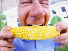 A patient biting into corn on the cob